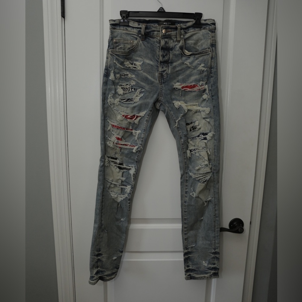 AMIRI Light Blue Distressed Skinny Jeans with Red Patch Accents